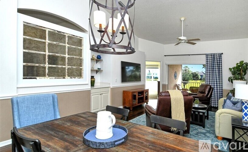 A dining room with a wooden table and chairs.