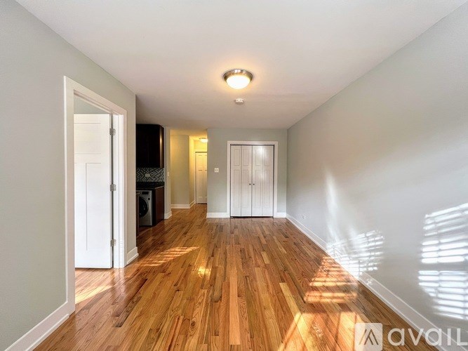 A room with wooden floors and white walls.