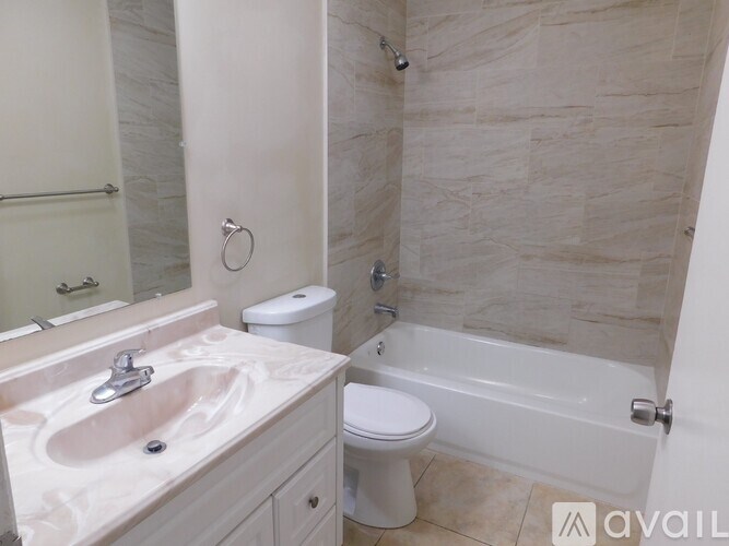 A bathroom with a sink, toilet, and bathtub.