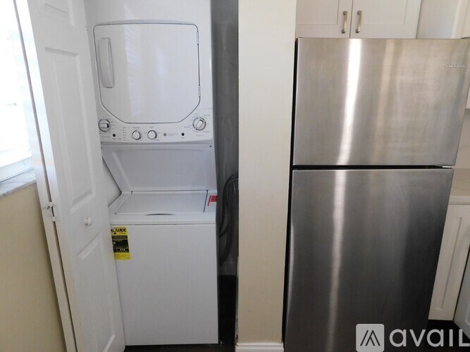 A white dishwasher is next to a silver refrigerator.