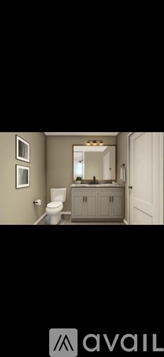 A bathroom with a toilet, sink, and mirror.