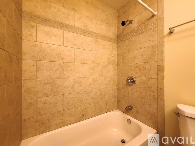 A bathroom with a tiled shower and a bathtub.