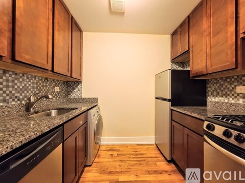 A kitchen with wooden cabinets and a black stove top oven.