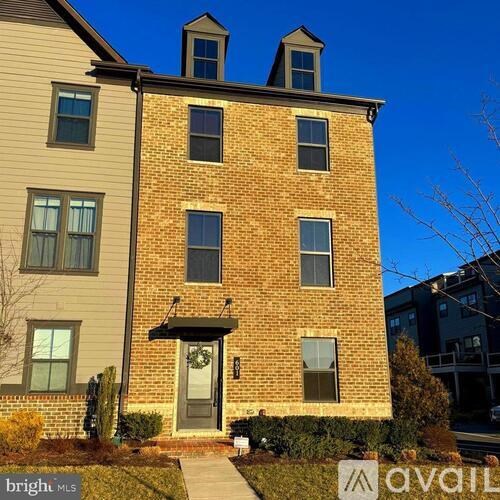 A two-story brick building with a balcony on the second floor.