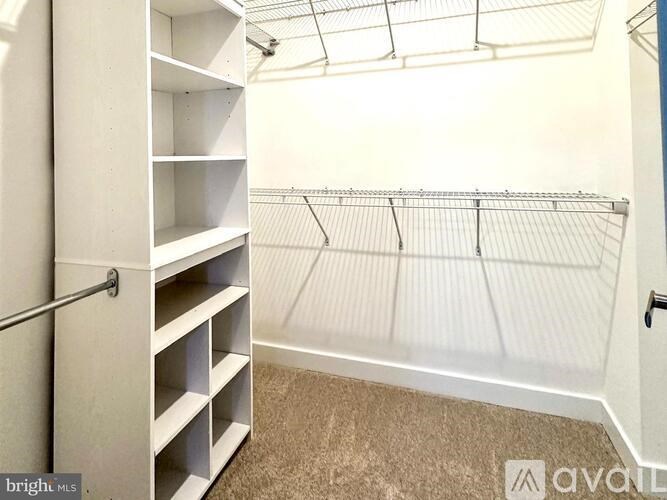 A white closet with shelves and a rod for hanging clothes.