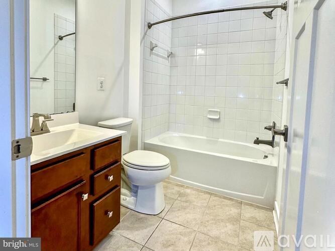 A white toilet sits next to a sink in a bathroom.