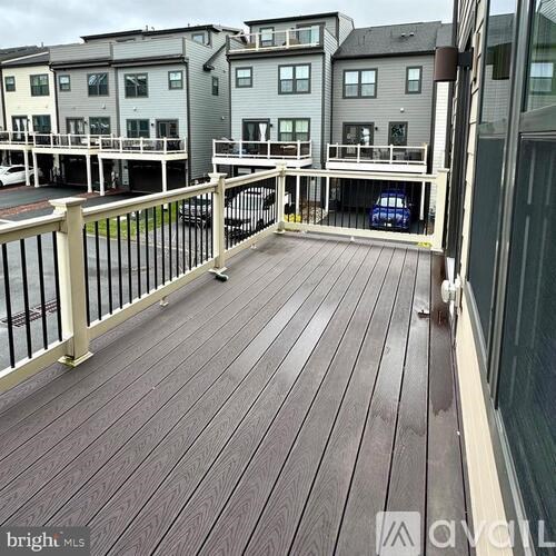 A balcony with a railing and a car parked in the background.