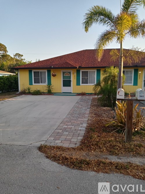 A house with a green and yellow exterior and a red roof.