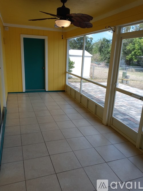 A room with yellow walls and a ceiling fan.