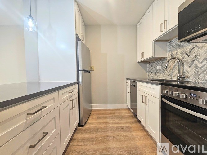 A kitchen with a white refrigerator and a black oven.