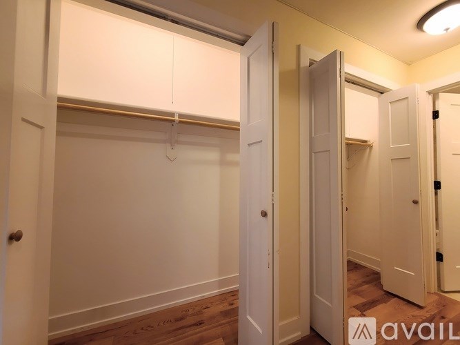 A room with a white door and a white wall.