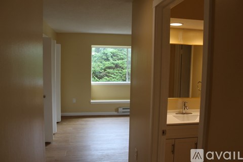 A bathroom with a window and a sink.