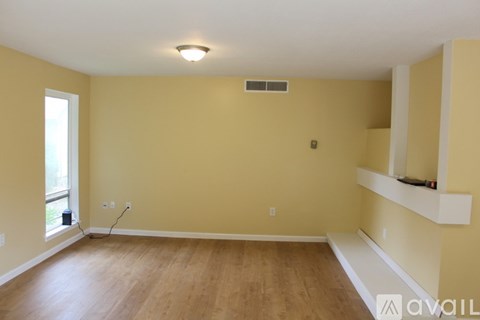 A room with wooden floors and a window.
