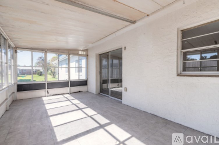 A spacious room with large windows and a view of the outdoors.