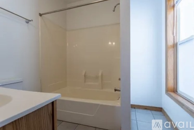 A small bathroom with a tub and sink.