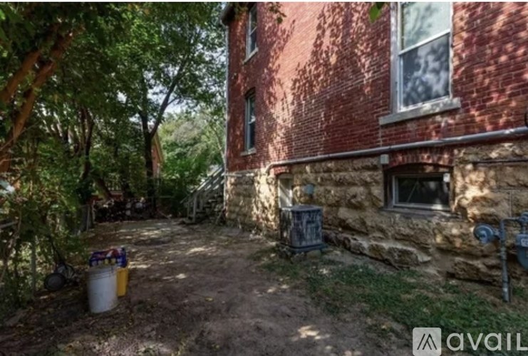 A red brick building with a tree in front of it.