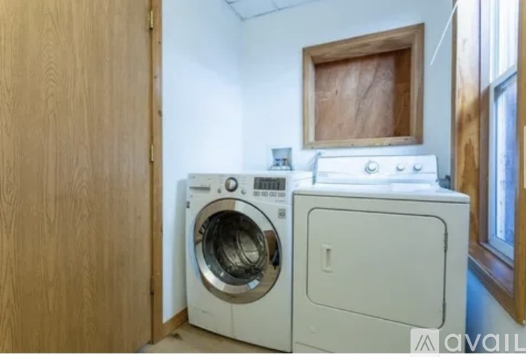 A washing machine and dryer are in a small room.