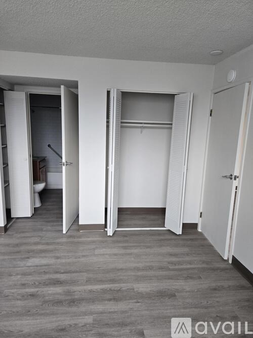 A room with a white door and a white wall.