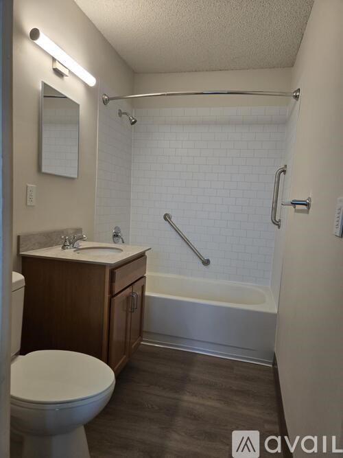 A bathroom with a toilet, sink, and bathtub.