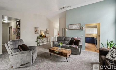 A living room with a grey couch and a coffee table.