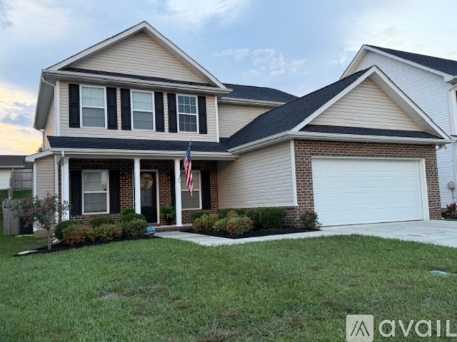 A house with a flag on the front porch is for sale.