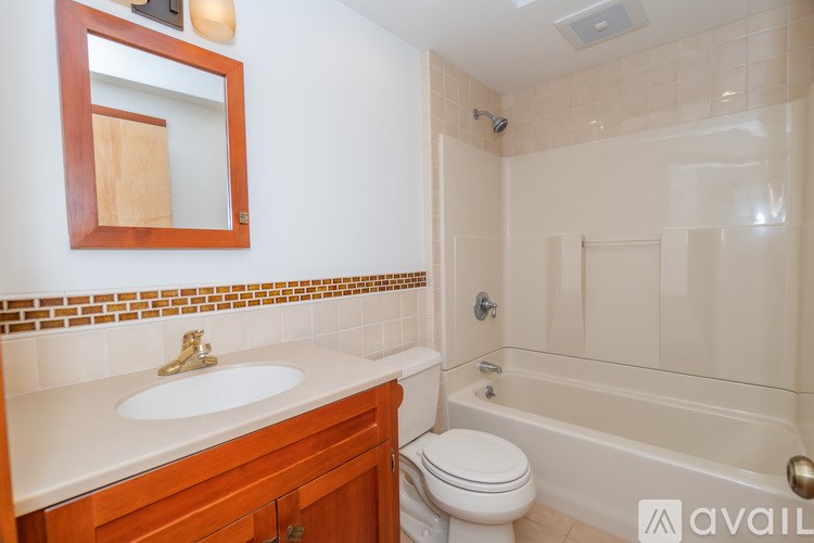 A bathroom with a sink, toilet, and bathtub.