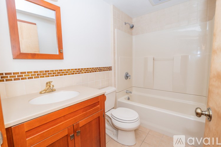 A bathroom with a toilet, sink, and bathtub.