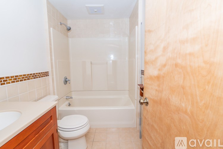 A bathroom with a toilet, sink, and bathtub.