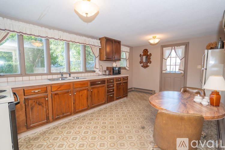 A kitchen with wooden cabinets and a patterned floor.