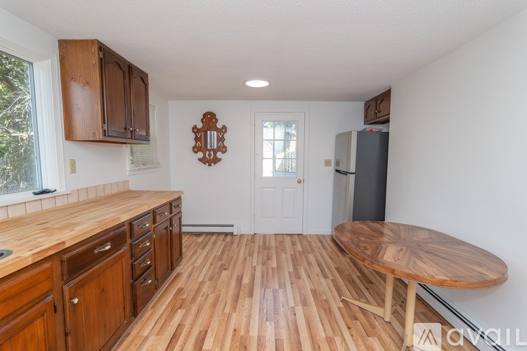 A kitchen with wooden floors and furniture.