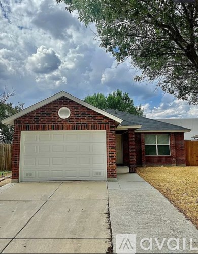 A house with a white garage door and a brick facade.