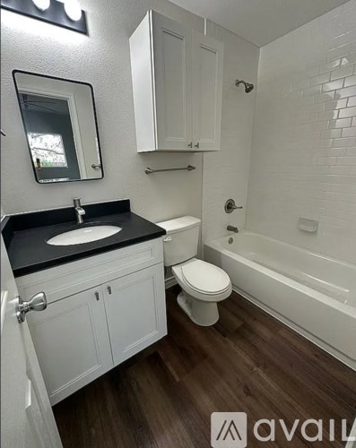 A bathroom with a sink, toilet and bathtub.