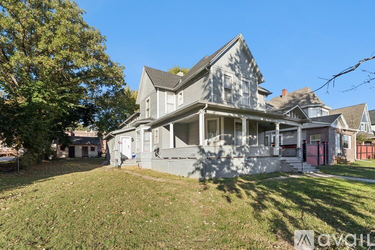 A large, two-story house with a front porch and a garage.