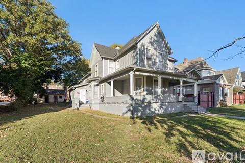 A large, two-story house with a front porch and a garage.