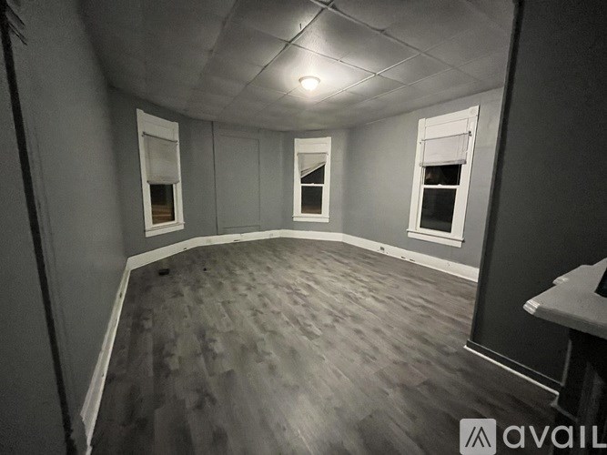 A room with grey walls and wooden flooring.