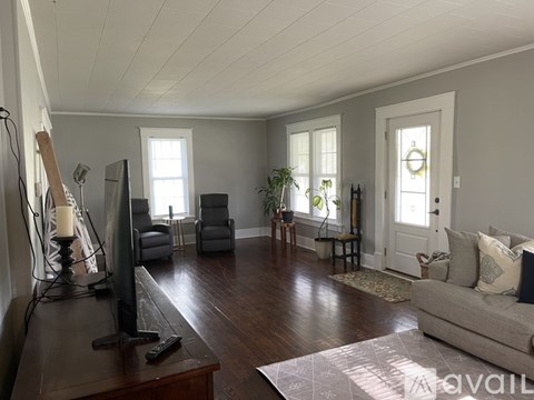 A living room with a television and a couch.