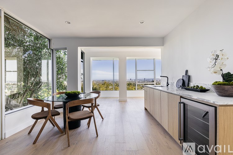 A modern kitchen with a dining table and chairs.