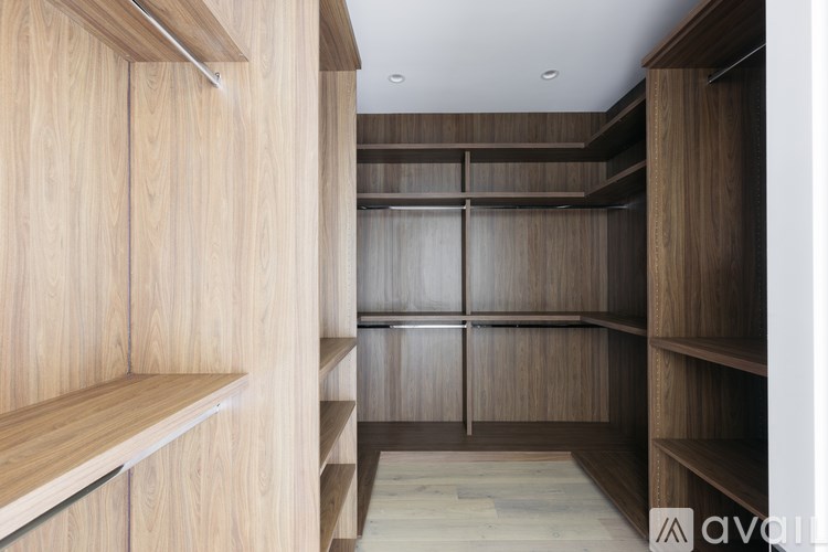 A room with wooden shelves and cabinets.