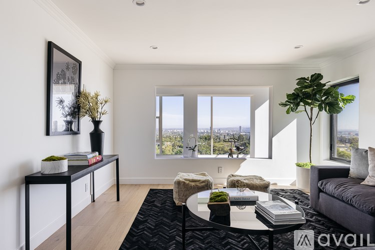 A modern living room with a large window overlooking the city.