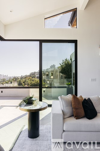 A modern living room with a white couch and a round coffee table.