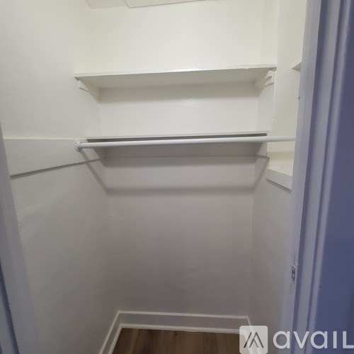 A white cabinet with a shelf and a drawer.