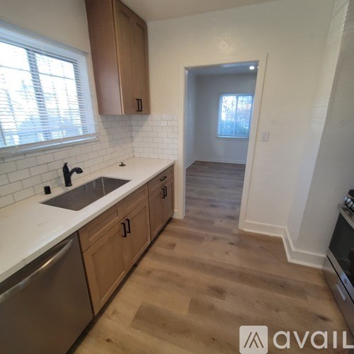 A kitchen with wooden cabinets and a white counter top.