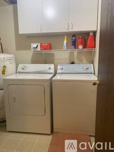 Two front loading washing machines in a laundry room.