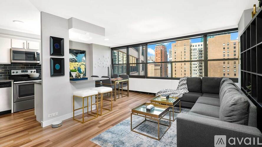 A modern kitchen with a large window overlooking a cityscape.