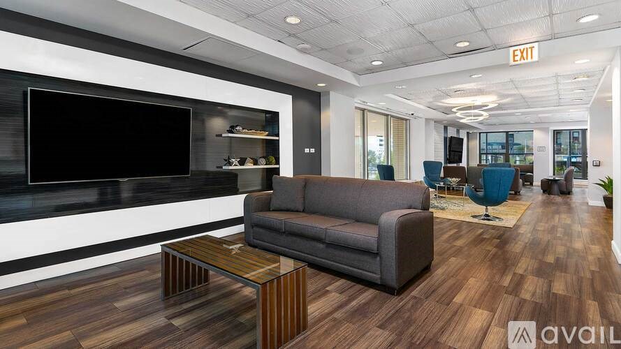 A modern living room with a grey couch and a wooden coffee table.