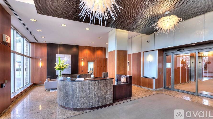 A reception area with a large desk and a vase of flowers on it.