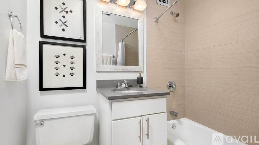 A bathroom with a white toilet, a sink, and a bathtub.
