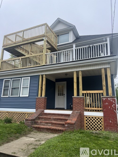 A house with a blue exterior and a partially constructed wooden deck.