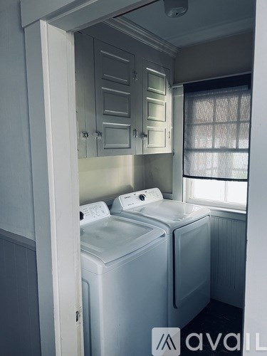 A small laundry room with a washer and dryer.