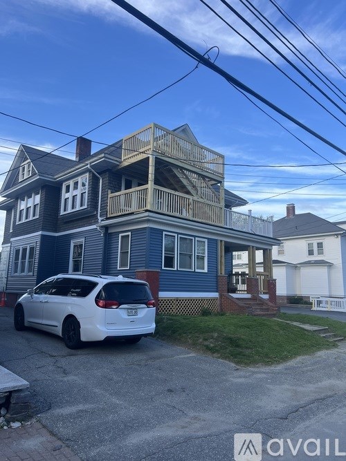A house with a car parked in front.